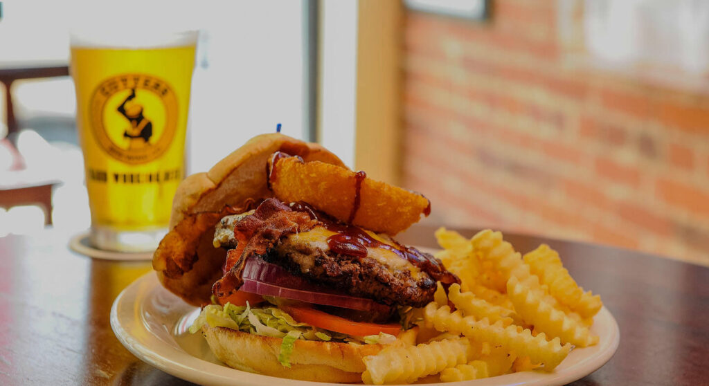 Burger, fries and a beer on a table