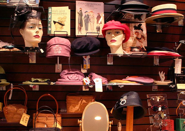 Hats and bags displayed on a store wall