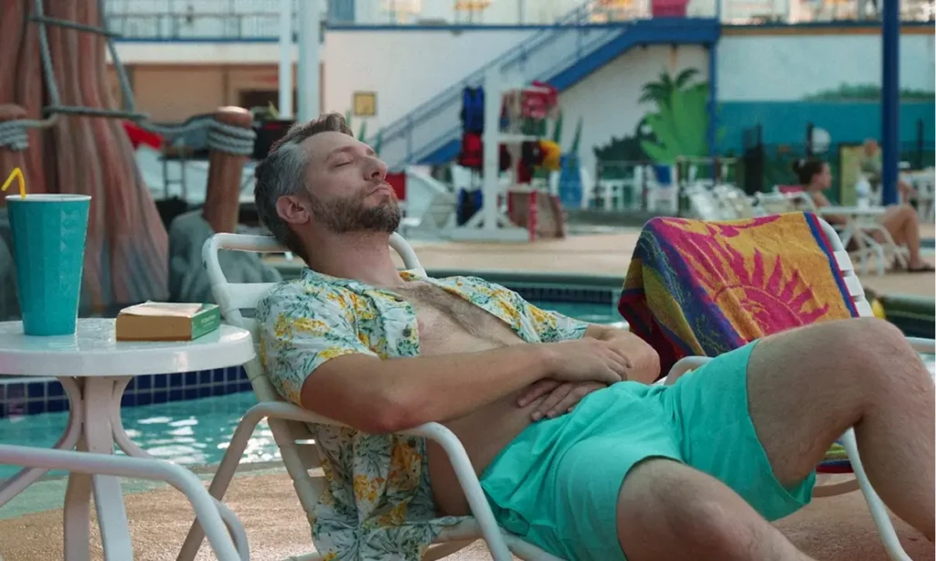 Man relaxing on a lounger at an indoor waterpark