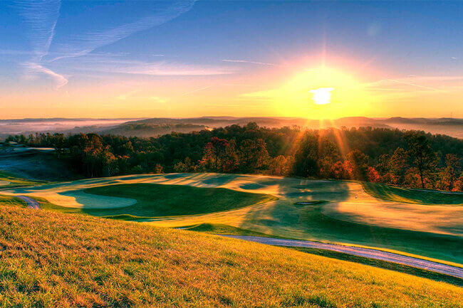 The sun setting over a golf course